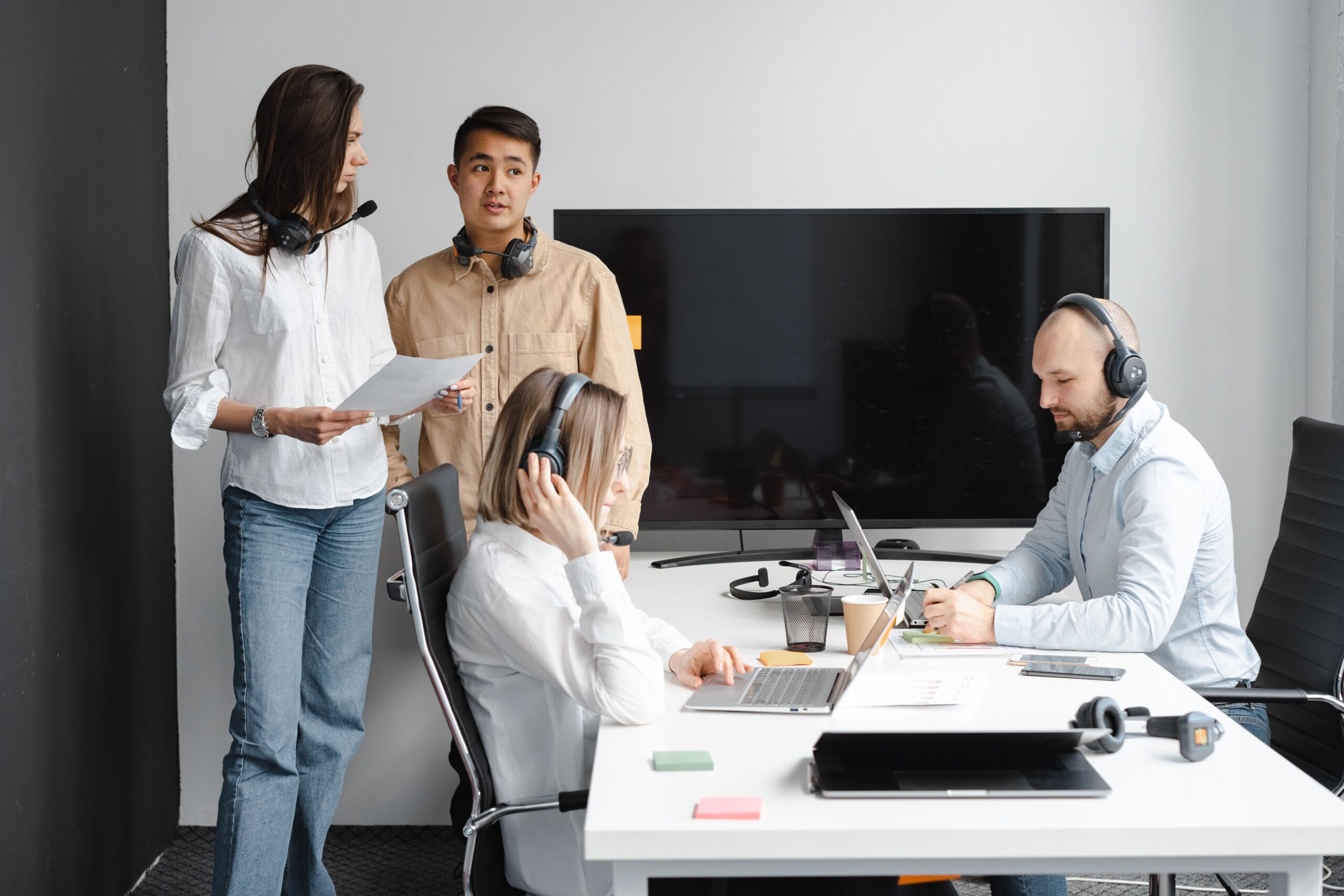 service-1 Group of call center agents working together in a modern office setting.